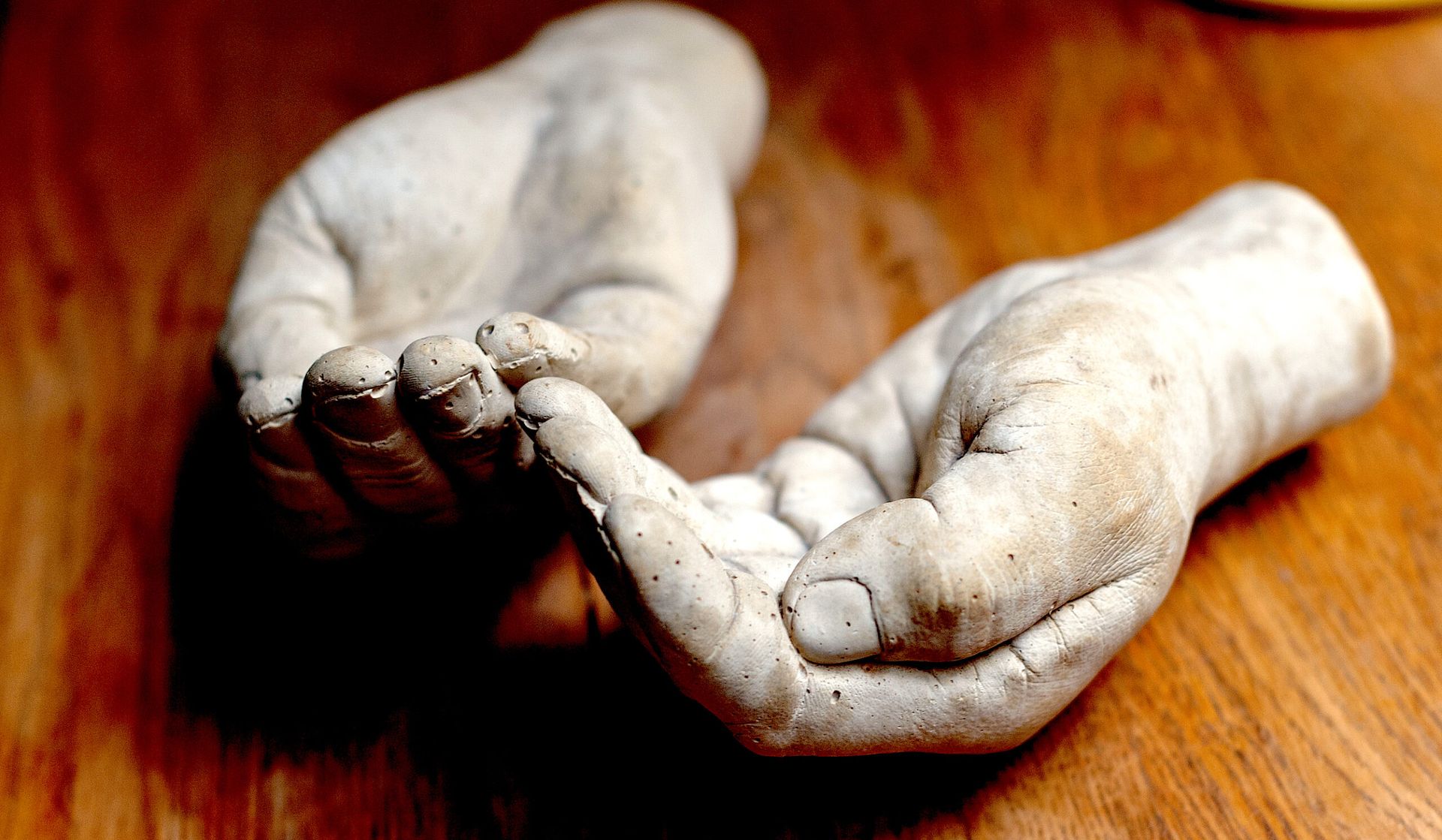 A picture of a sculpture in the shape of hands on a desk at The Whole Works Complementary Therapy and Counselling Centre Building